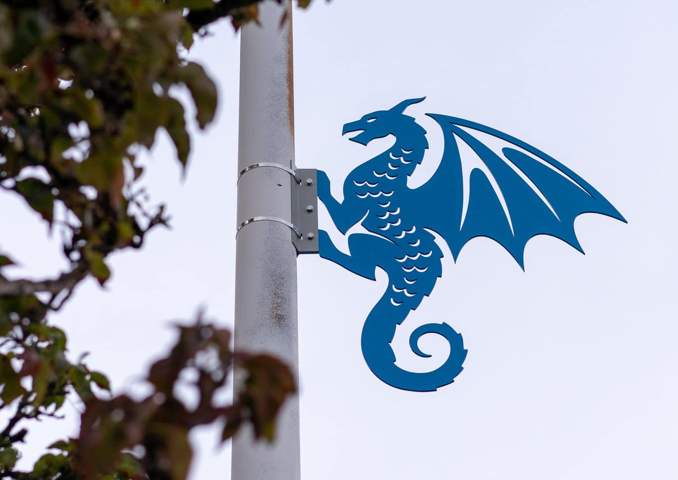 Blue metal dragon sculpture on a light pole in downtown Renton