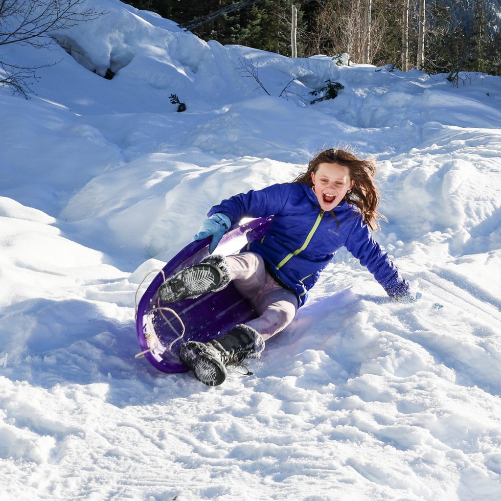 photo of a child sledding
