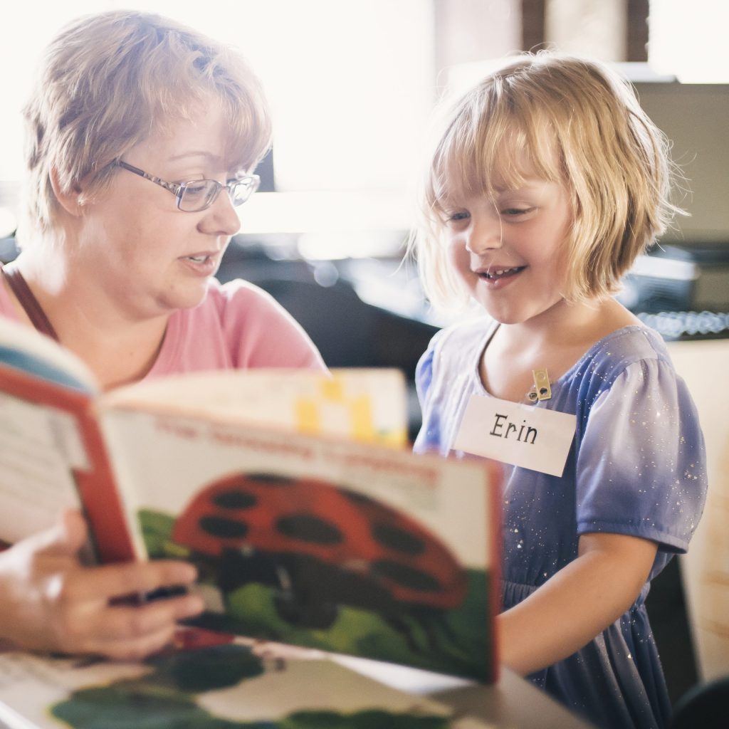 image of Tacoma Public Schools teacher reading to a young student