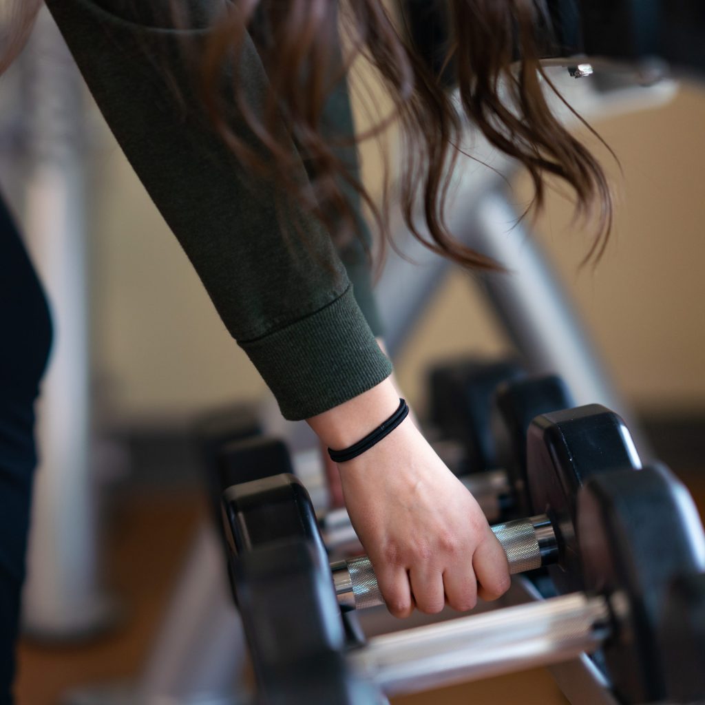photo of a person picking up weights at the gym at Summit Pacific Medical Center