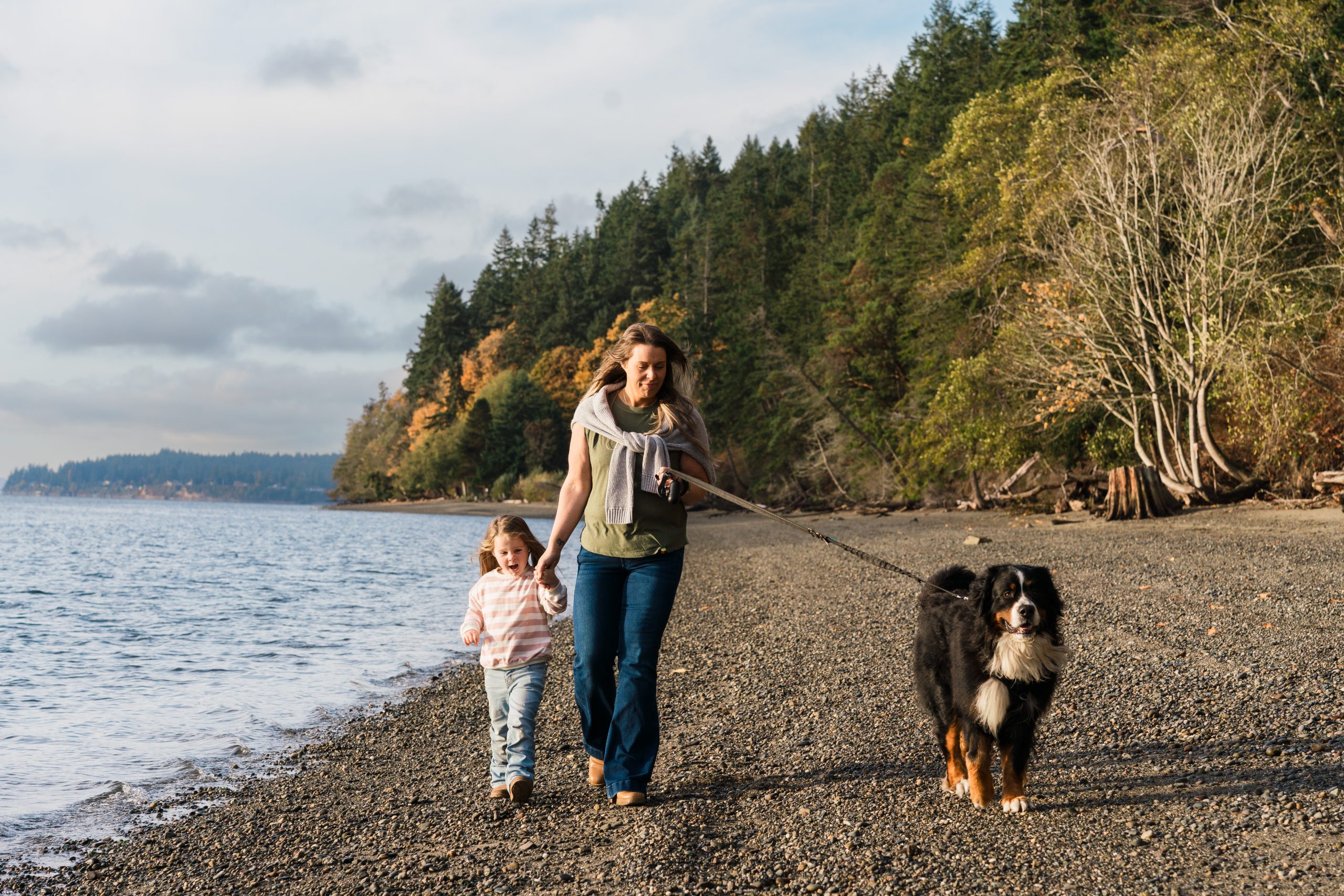 A mom and daughter walk their St. Bernard along Narrows Beach in Gig Harbor