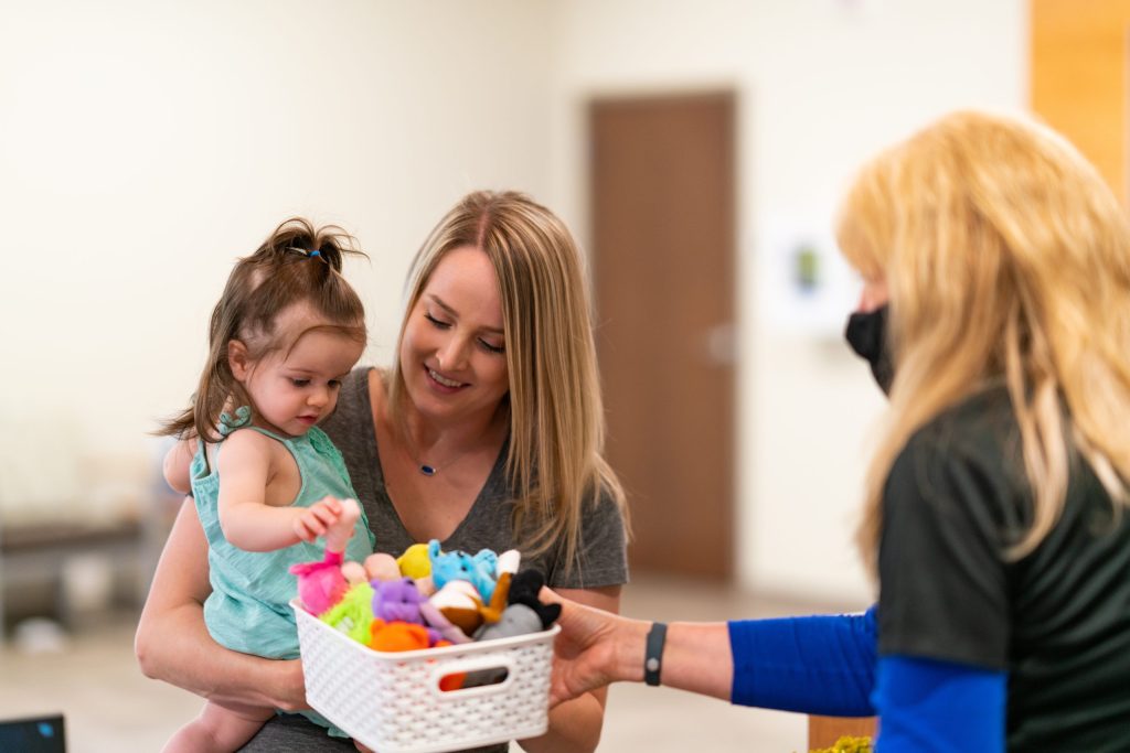 Photo of nurse attending to a small child with their mother at Summit Pacific Medical Center
