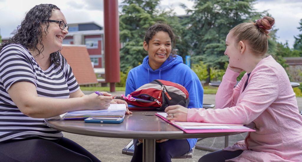 Photo of Tacoma Community College students studying and interacting at a table
