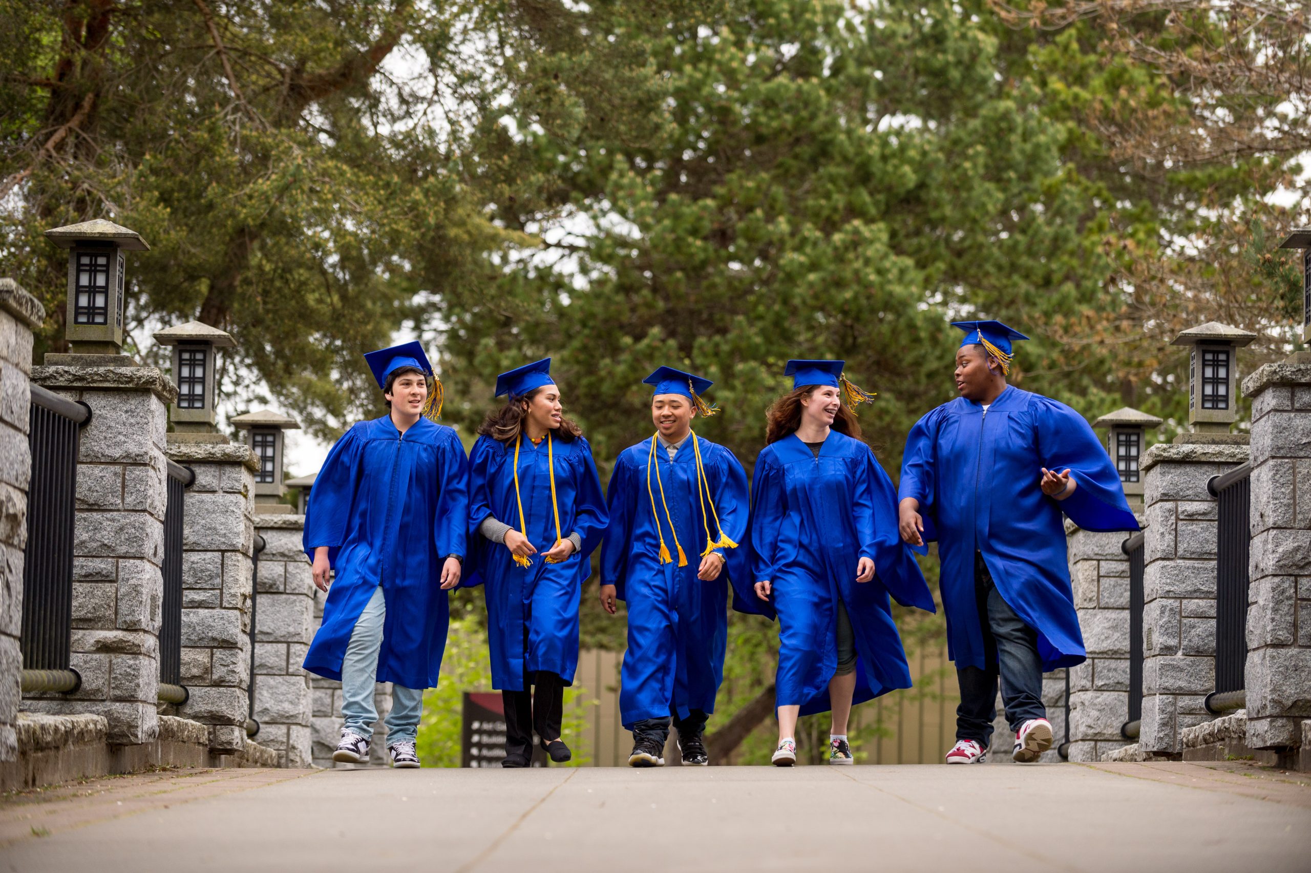 Photo showing Tacoma Community College students posing for a photo in their cap and gowns on graduation day