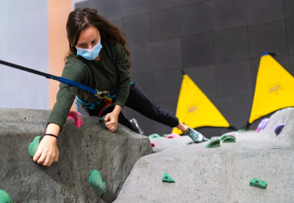 photo of a person rock climbing at a gym