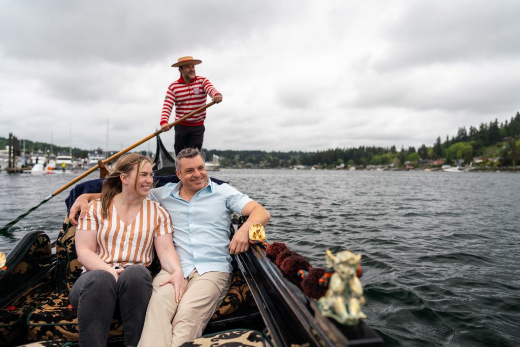A couple relaxes in a gondola ride through the harbor