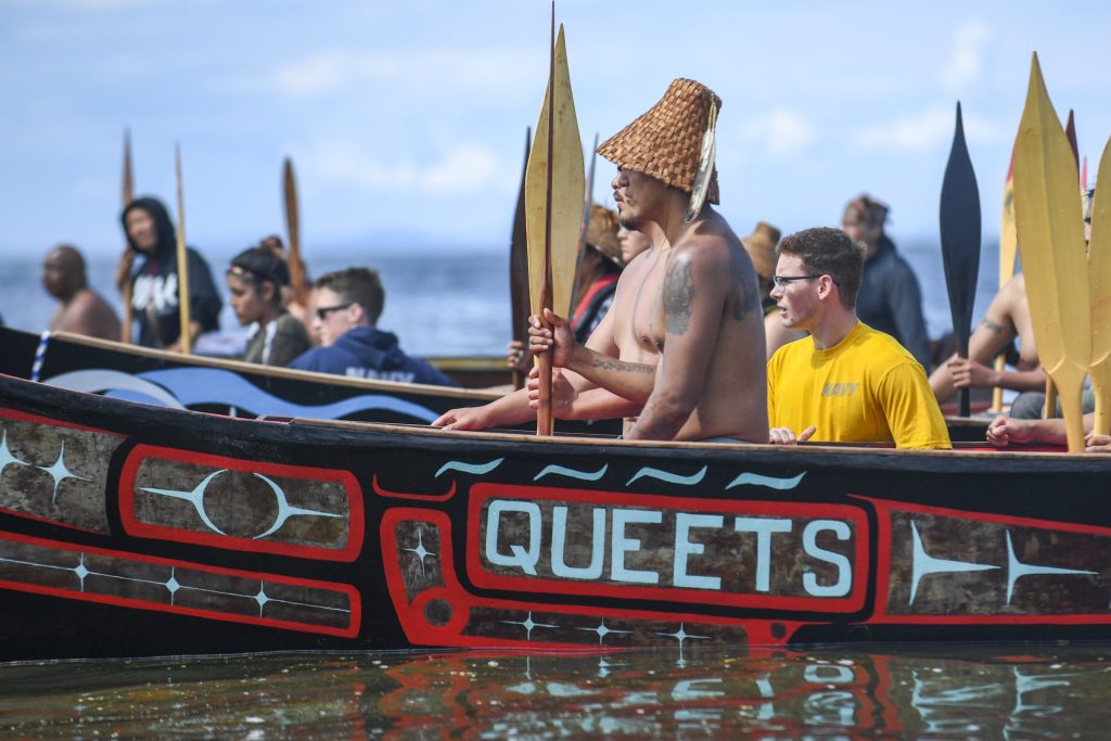 Photo of people in boats lined up for the Olympic Paddle to Lummi Tribal Journey