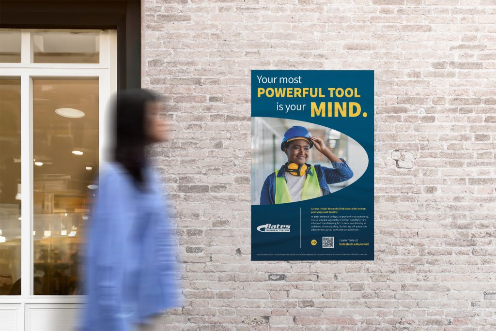 Photo showing a student looking at a Bates Technical College poster