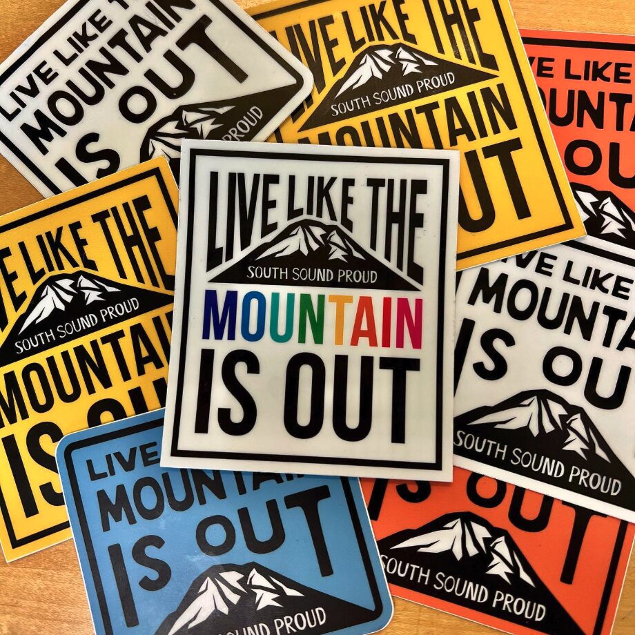 A layered view of several colorful Live Like the Mountain is Out stickers