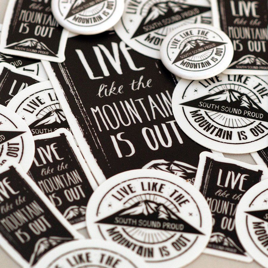 A layered view of several Live Like the Mountain is Out stickers