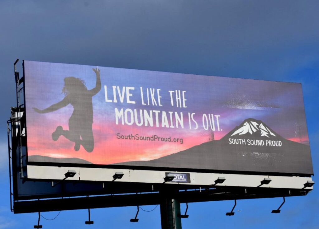 A billboard featuring a Live Like the Mountain is Out ad