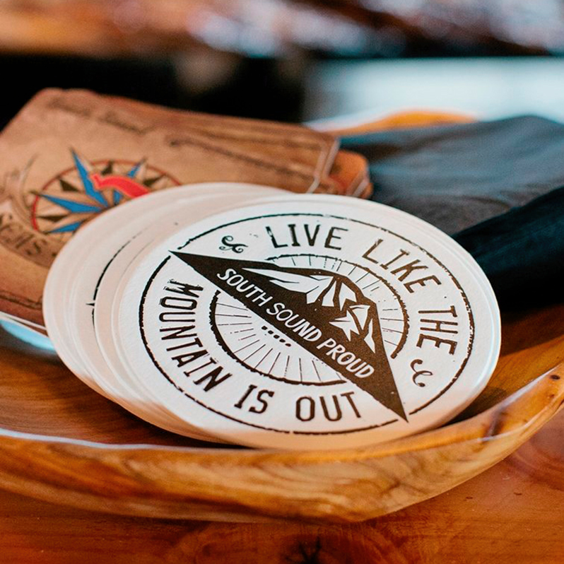 A stack of Live Like the Mountain is Out coasters
